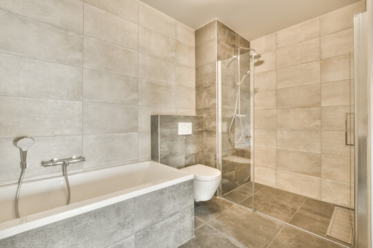 Shower cabin and sink in modern illuminated bathroom