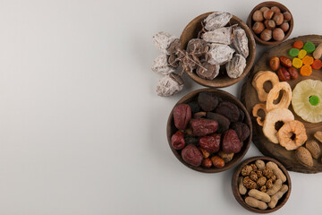 Fototapeta na wymiar Dry fruits and snacks in multiple wooden platters and saucers