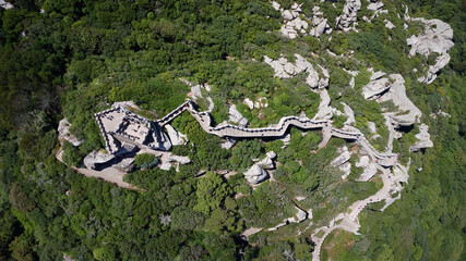 Aerial drone view of  Moorish Castle  Sintra, Portugal during a sunny day. Unesco World Heritage. Historic visits. Holidays and summer vacation tourism. Sightseeing
