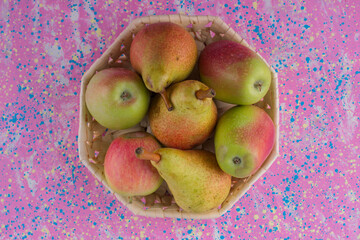Green pears and apples in a basket