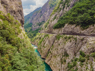 Obraz premium The purest waters of the turquoise color of the river Moraca flowing among the canyons. Travel around Montenegro concept Portrait of a disgruntled girl sitting at a cafe table