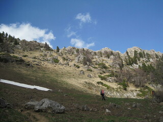 walking man on the background of a mountain slope