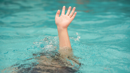 emergency kid drowing in swimming pool show up hand call for help
