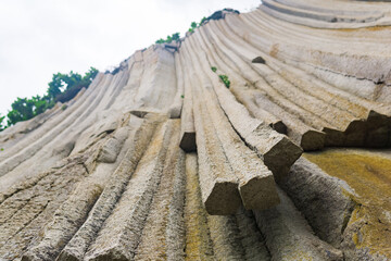 basalt columns forming a coastal rock at Cape Stolbchaty on Kunashir Island, close-up