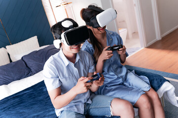 excited married couple play vr glasses. cheerful wife and husband enjoy virtual reality together...