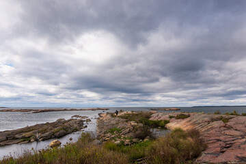 The rocky shore of Georgian Bay looking out to the horizon with a cloud filled sky.  Room for text.