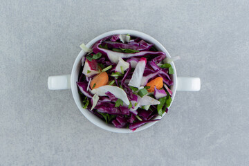 Various vegetables in the cup, on the marble background
