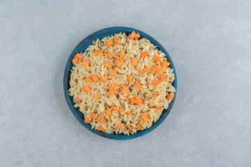 Fototapeta na wymiar Carrot rice in the wooden plate , on the marble background