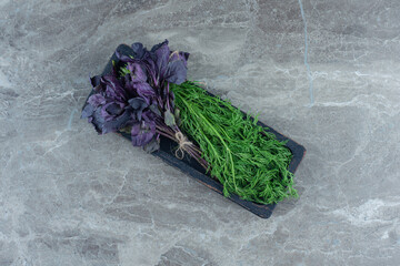 Purple basil and dills on tray , on the marble background
