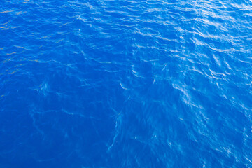 Very nice sea water background or backdrop with selective focus. Small waves of natural water surface texture.