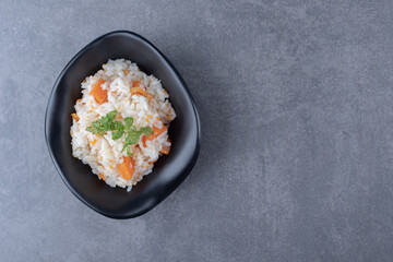 A bowl of carrot rice , on the marble background