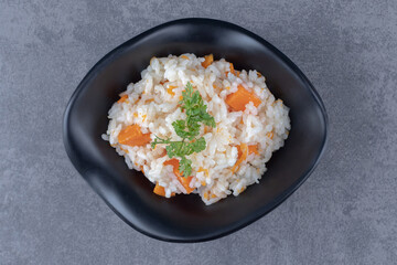 A bowl of carrot rice , on the marble background