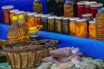Farmers market in Bursa Turkey, selling homemade pickles, olive oil, and herbs