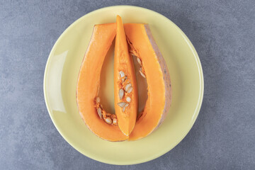 Sliced zucchini on a plate, on the marble background