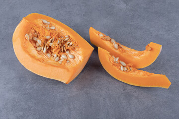 Three pieces of pumpkin , on the marble background