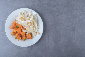 Delectable sliced lavash and baked carrot in plate , on the marble background