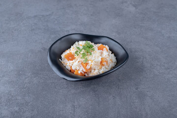 A bowl of carrot rice , on the marble background