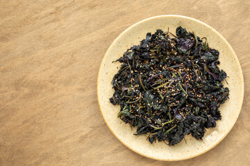 Asian style stir fried shiso (perilla) leaves with sesame seeds.