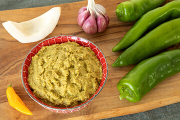 Green pepper and coconut chutney with main ingredients: green peppers, fresh coconut, fresh chili, garlic bulb.