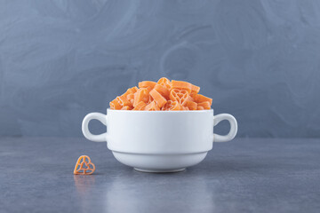 Pile of raw heart-shaped pasta in mug