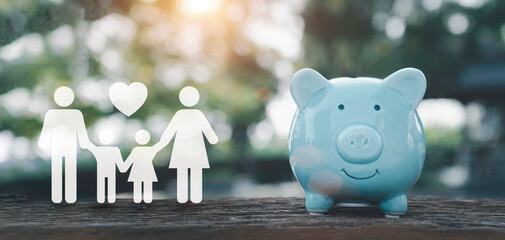 Saving, charity, family finance plan concept, fundraising,blue piggy bank and icon family on table, investment, financial crisis concept.