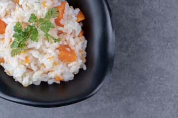 A bowl of carrot rice , on the marble background