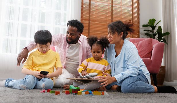 A Multi-ethnic Family Had Lovely Sons And Daughters Sitting And Chatting Happily.