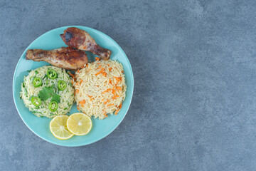 Fototapeta na wymiar Fried chicken legs and rice on blue plate