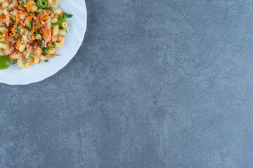 Tasty pasta with chopped vegetables on white plate