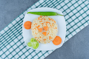 Steamed rice with chopped carrots on white plate