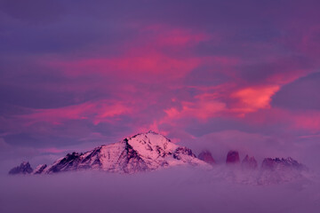 Winter twilight lanscape from Patagonia moutains with snow. Lago Nordenskjold, Torres del Paine National Park, Chile. Pink blue evening sky. Traveling in Chile,  hills in Torres del Paine NP.