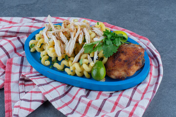 Grilled chicken and pasta on blue plate