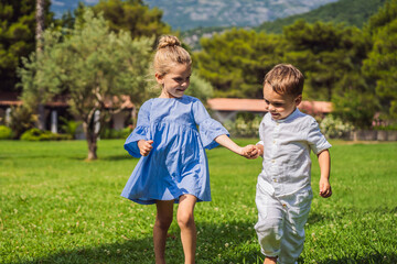 Cute little children on green grass in park