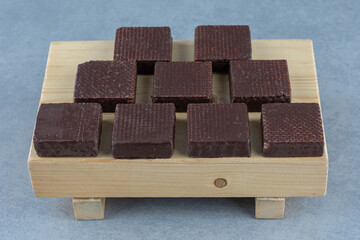 Chocolate coated on crispy wafer bar on the board, on the marble background