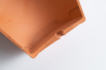 Broken terracotta pot close up on isolated white background. Manufactured defect. Shipment risk.