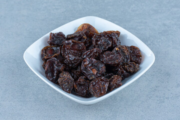 A bowl of dried cherry, on the marble background
