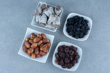 An arrangement of various Turkish delight flavors on a wooden board on marble background