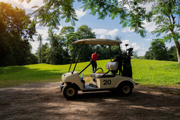 Golfcar in beautiful golf course in the evening golf course with sunshine
