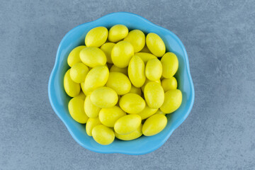 Yellow gums in the bowl, on the marble background