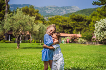 Fototapeta premium Cute little children on green grass in park