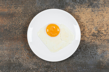 Delicious fried eggs on white plate