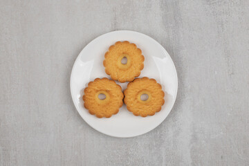 Tasty sweet biscuits on white plate