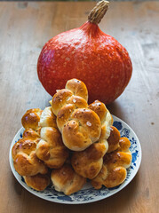 Baked buns with pumpkin in background