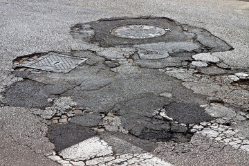 Old damaged, dangerous and broken asphalt road background