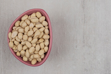 Organic tasty peanuts in pink bowl