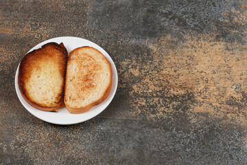 Crispy toasted bread on white plate