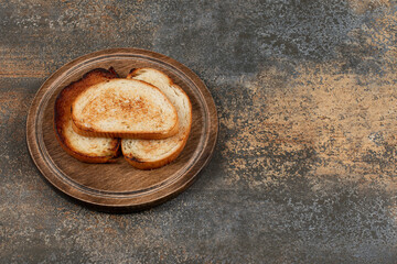 Three toasted bread on wooden board