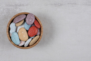 Colorful various stone candies in wooden bowl