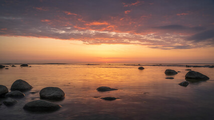 Fototapeta na wymiar Calm orange sunset on the evening sea