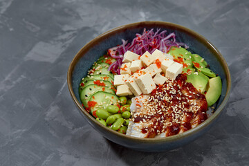 Hawaiian dish. Poke salad with eel on a gray background